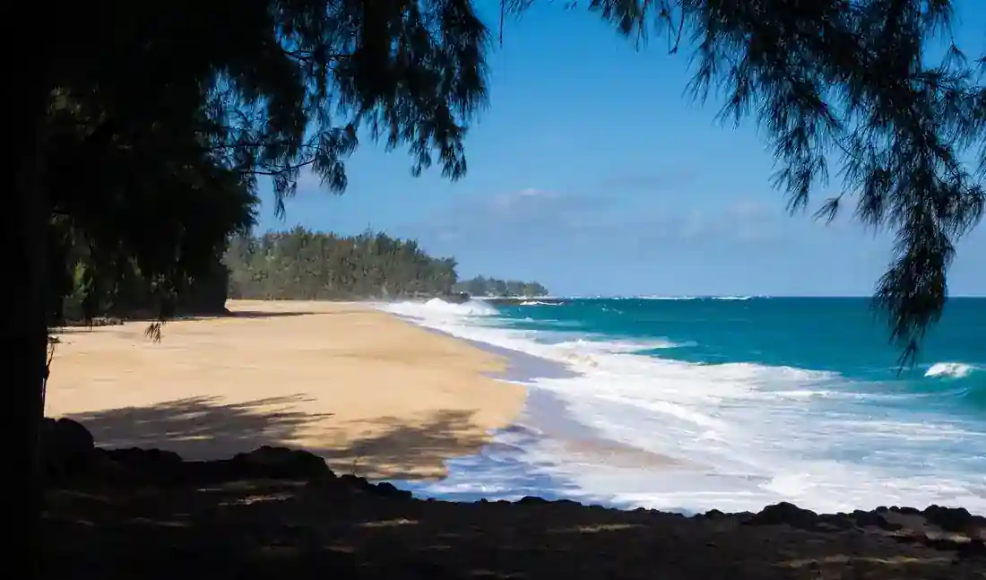 Sunny beach with waves rolling onto the sand